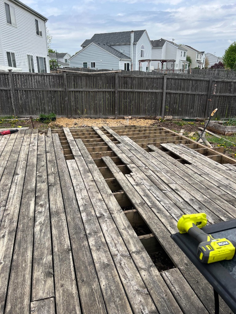 Deck removal and framing work in backyard